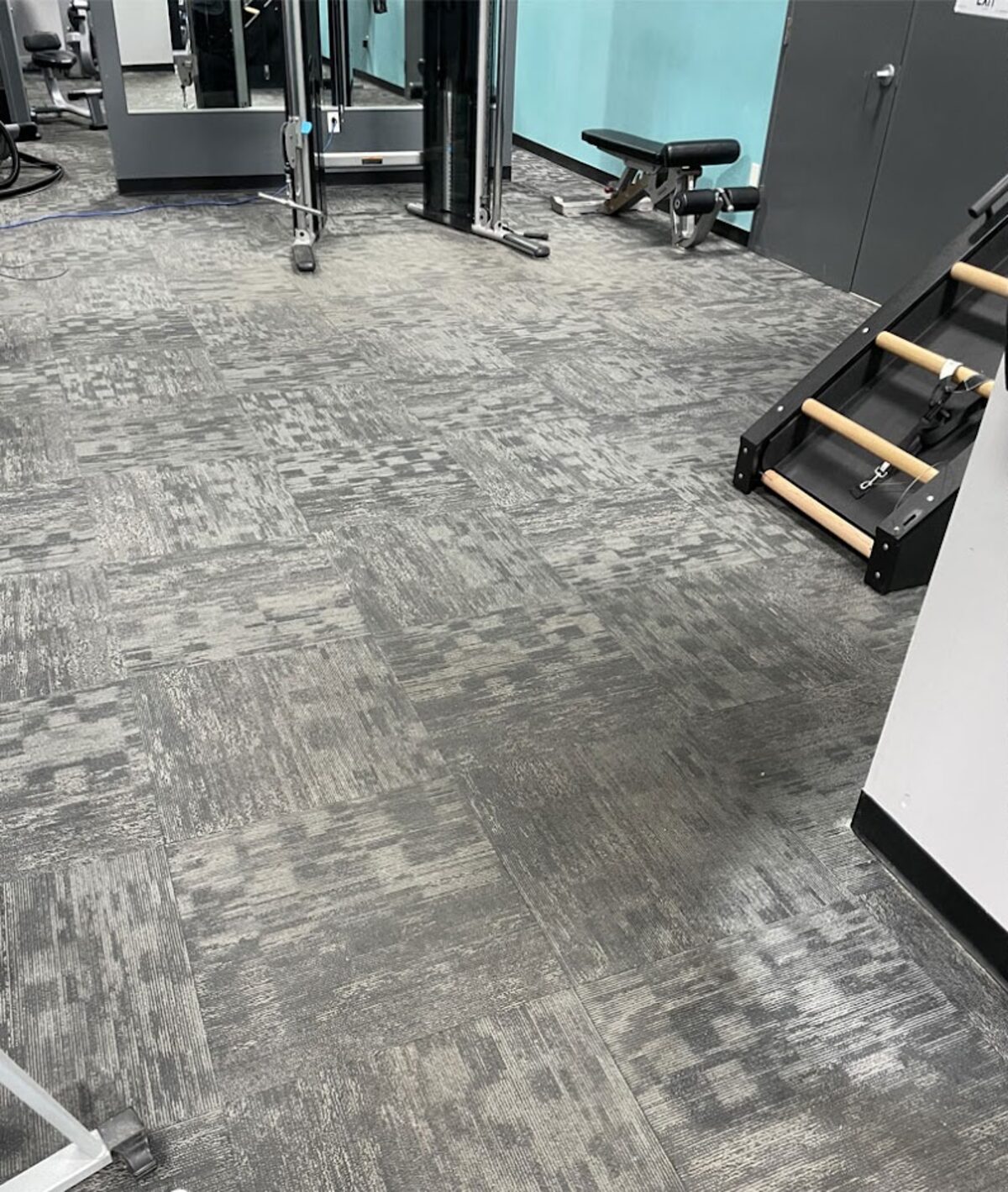 Carpet tile in a commercial gym, before cleaning